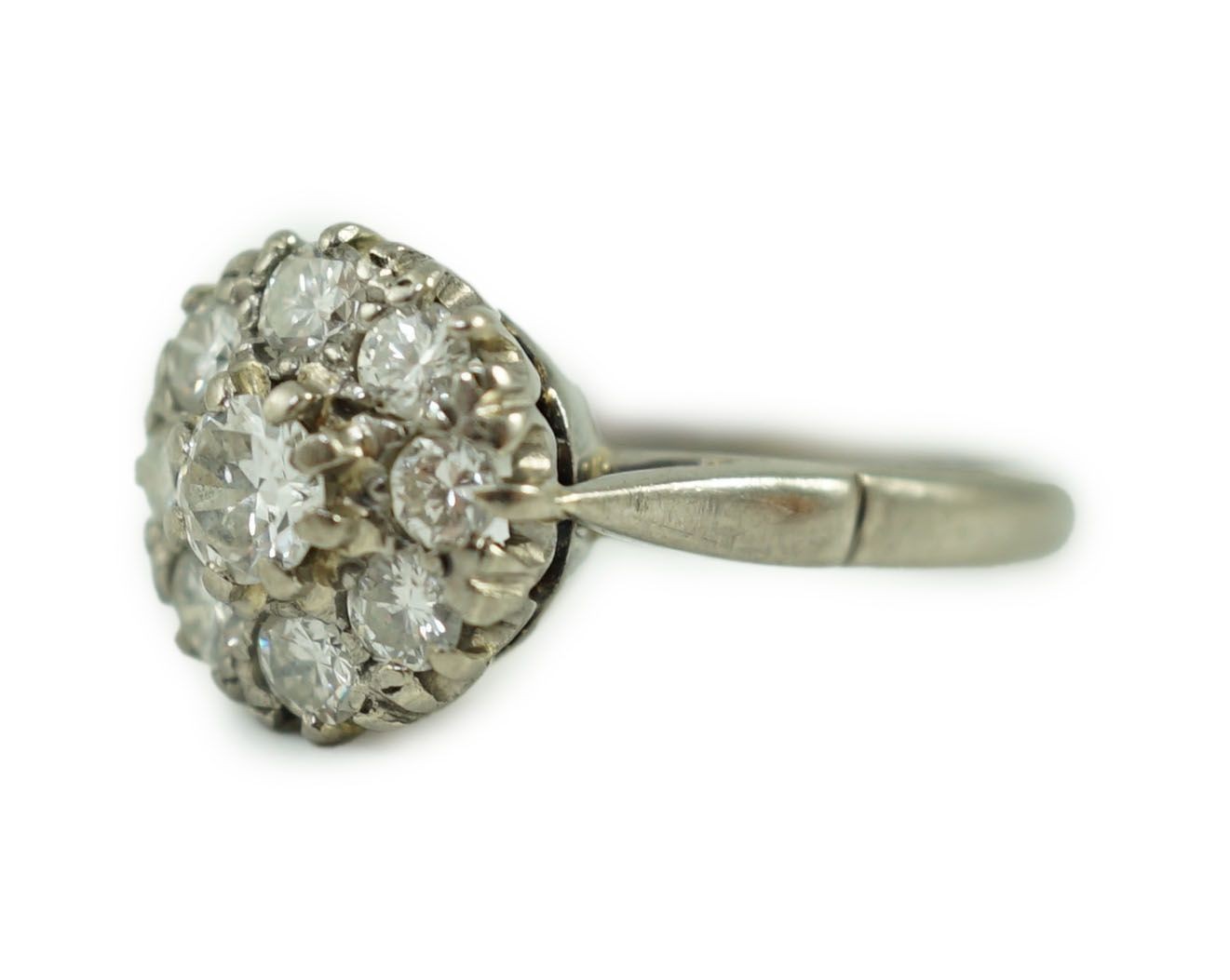 An 18ct white gold and nine stone diamond flower head cluster ring